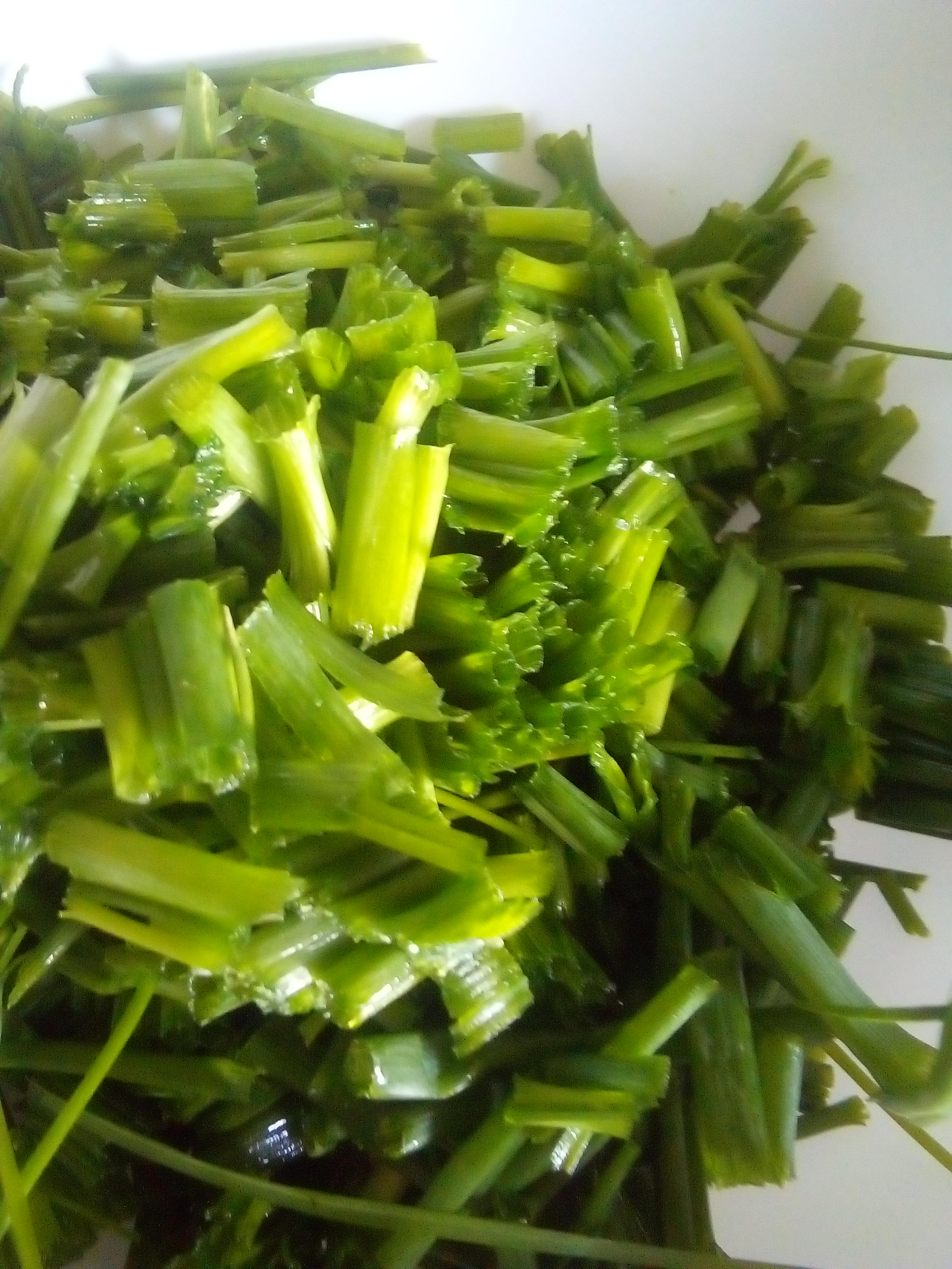 Freshly cut chives sprinkled over warm buttered potatoes