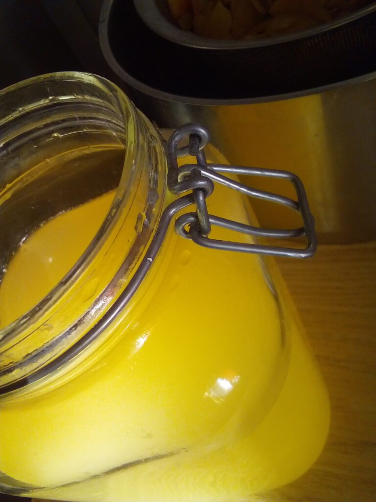 Apples bubbling and fermenting in water during vinegar making process
