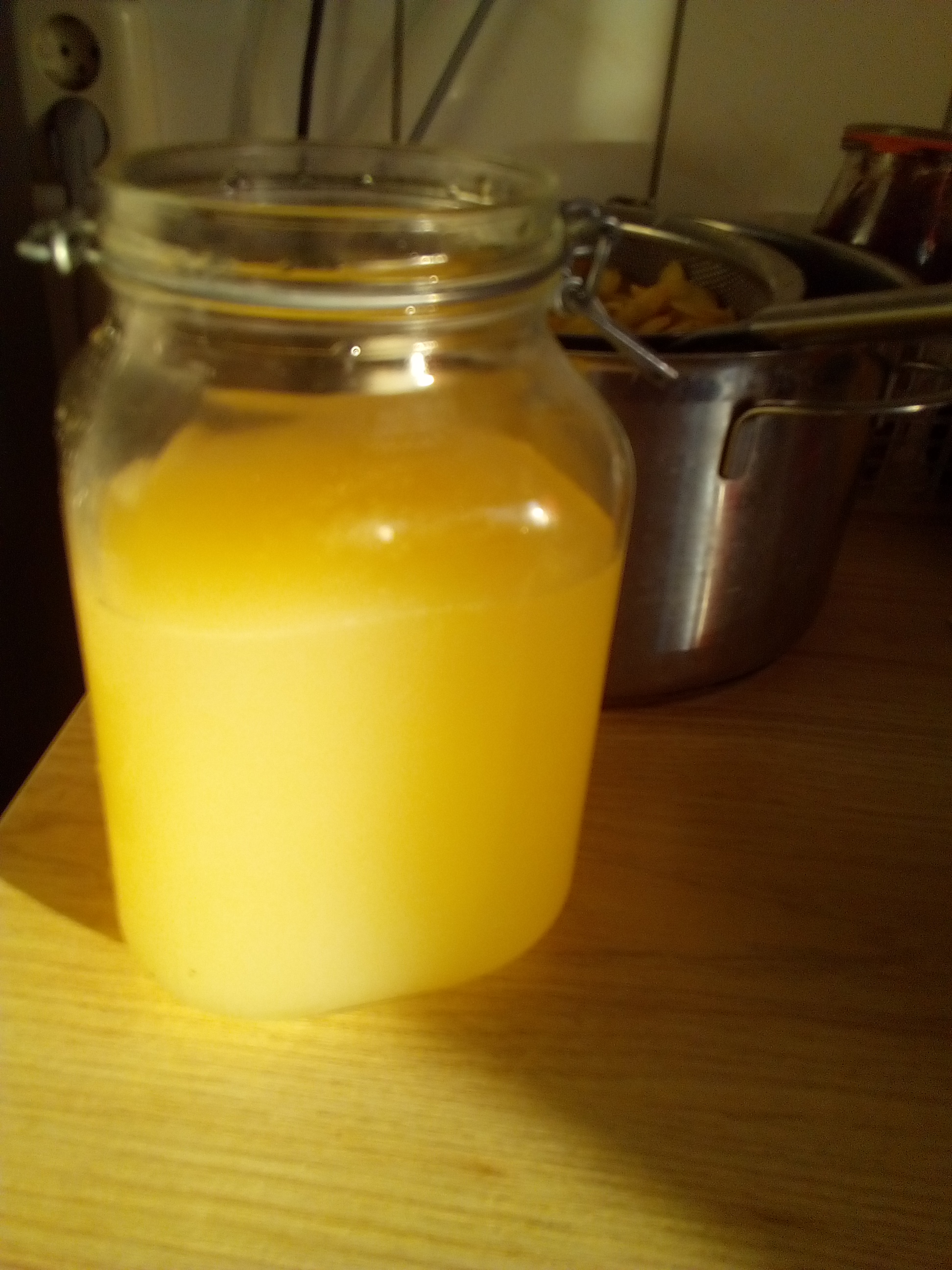 Adding water to chopped apples in a jar for fermentation