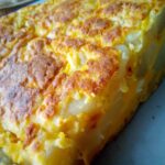 Authentic Spanish tortilla recipe cooked in a non-stick skillet – traditional Spanish food with potatoes and eggs.