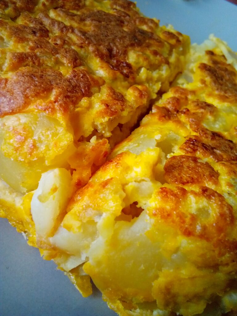 Spanish tortilla recipe served with a fresh salad side – healthy and budget-friendly Spanish food.