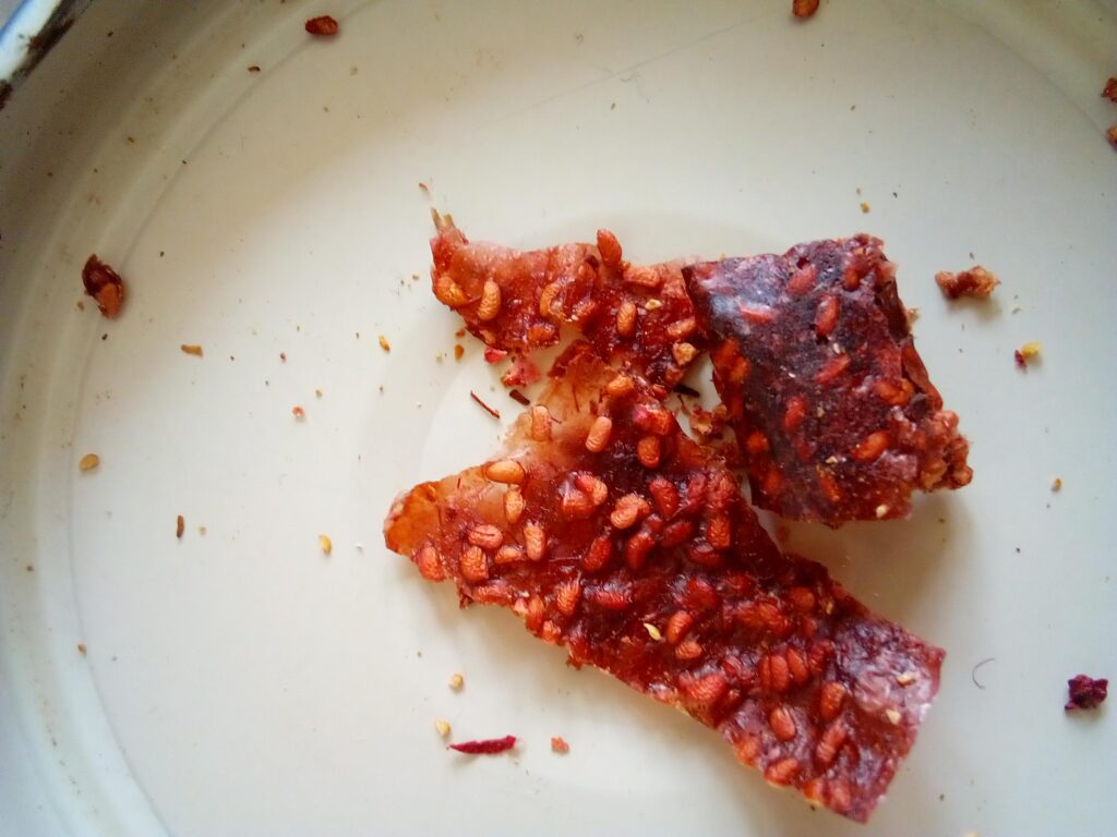Small pieces of raspberry fruit leather after 12 months of storage in airtight glass jar.