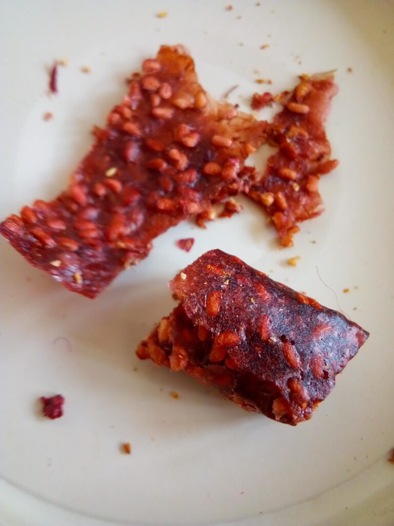 Raspberry fruit leather showing faded deep wine-red color after one year of pantry storage.