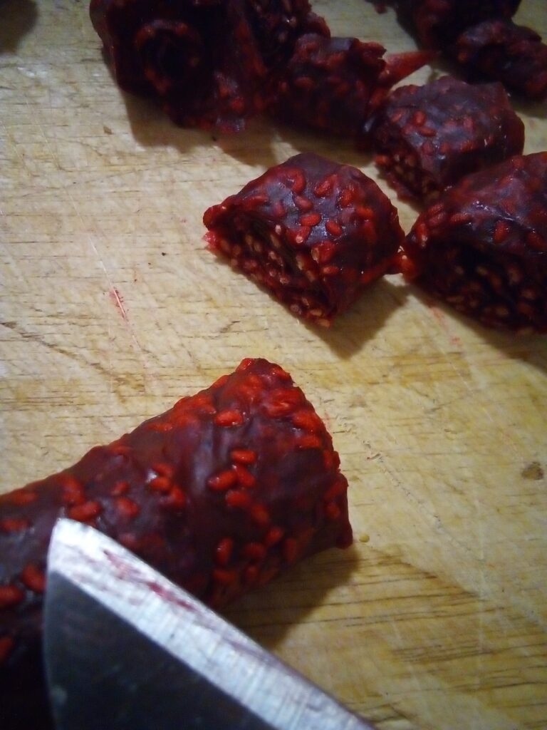 Checking raspberry fruit leather for doneness after 10 hours in a dehydrator.