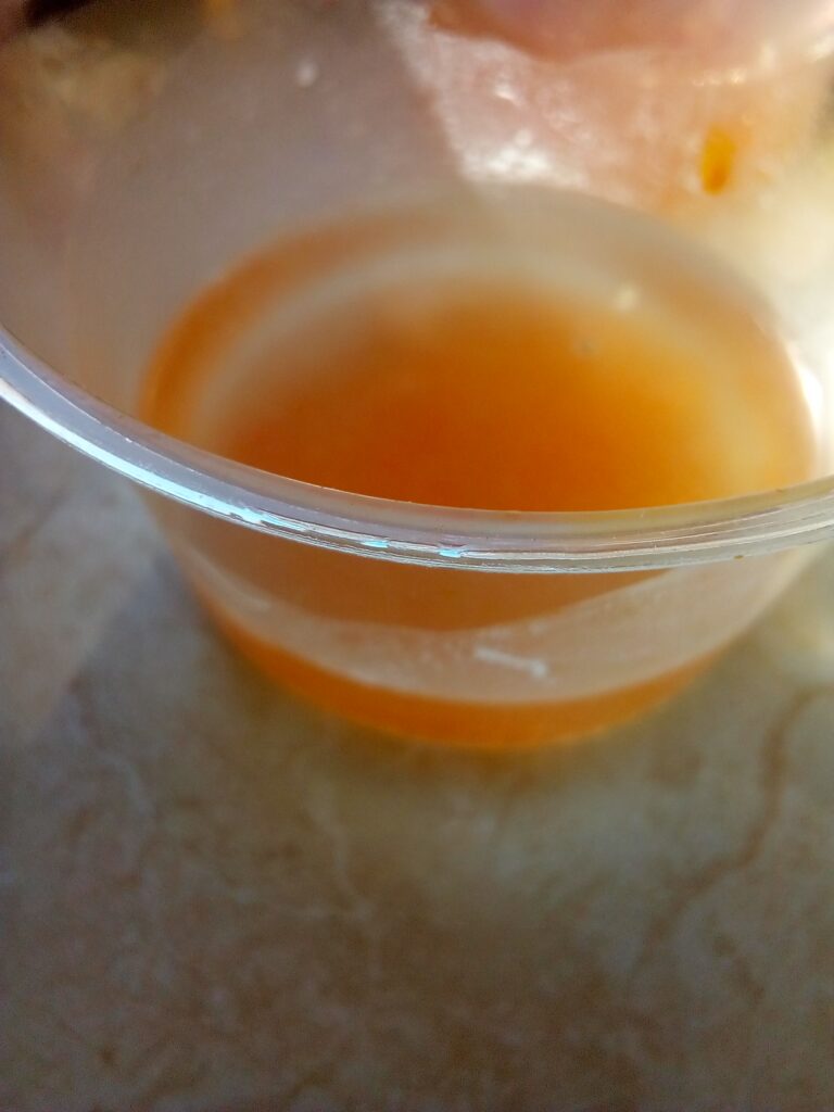Tomato seeds stored in airtight glass jar with label