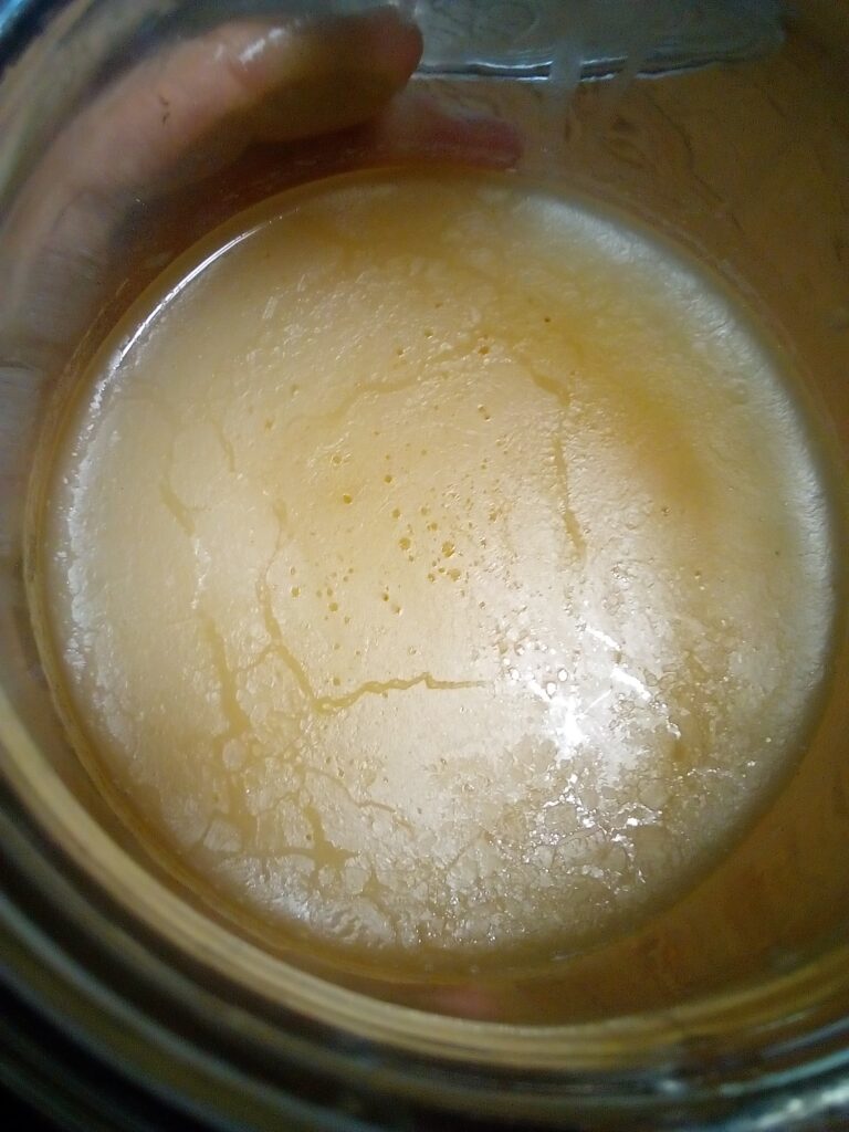 7.	Traditional goose fat rendering and filtering in a home kitchen.