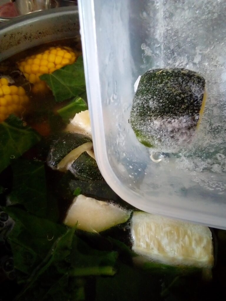 Clear beef soup cooking with bone broth and vegetables showing a gentle simmer for traditional homestead style soup preparation.