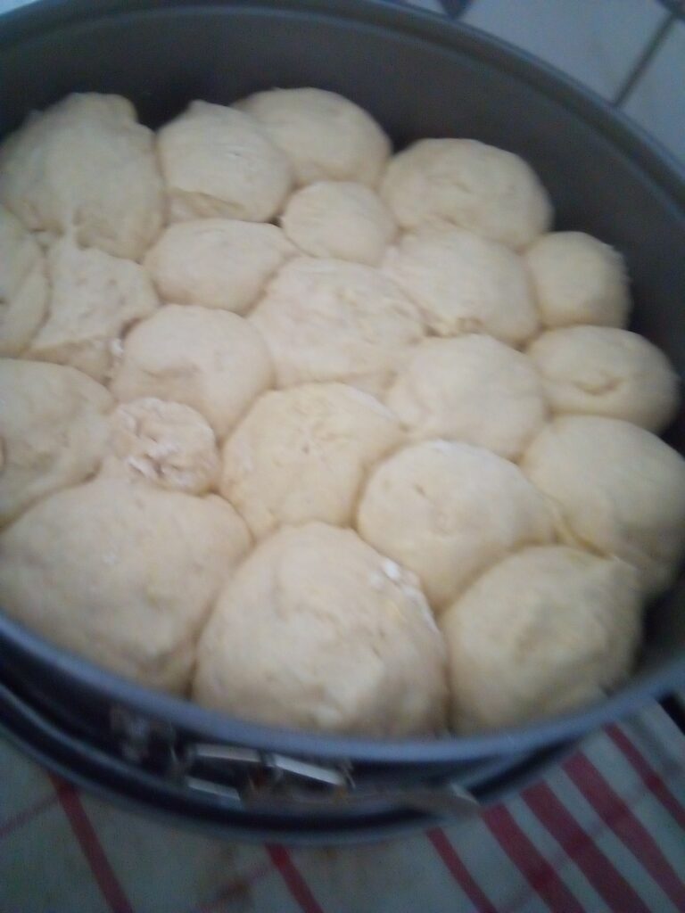 Hand-mixing yeast dough with grated pattypan squash