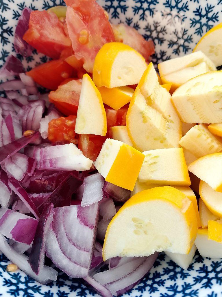 Busy mom preparing a zucchini tomato skillet for a quick lunch