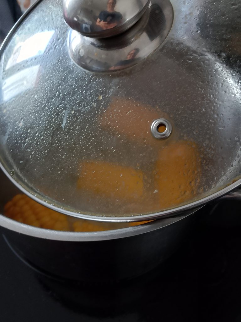 How to meal prep vegetables for the week with simple vegetables prepared ahead of time, including carrots, broccoli, potatoes, green beans and corn.